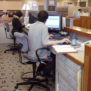 a library technician using a computer