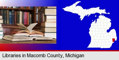 books on a library table and on library bookshelves; Macomb County highlighted in red on a map